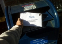 Vote by Mail ballot being placed in a US mail box