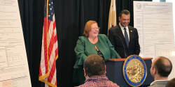 LWVC ED Melissa Breach speaks about new voter registration form at press event on 4/5/18.